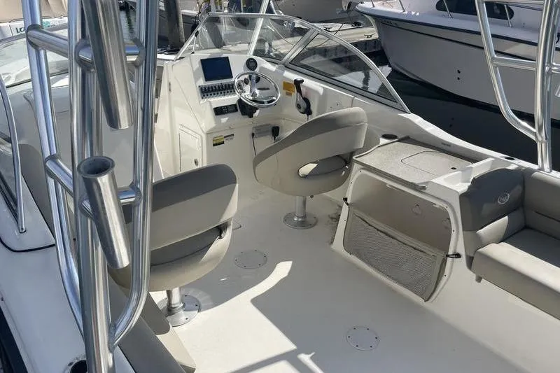 Slide: The Image of 2021 Key West 239 DFS boat interior with helm, seating, and modern controls. - 9
