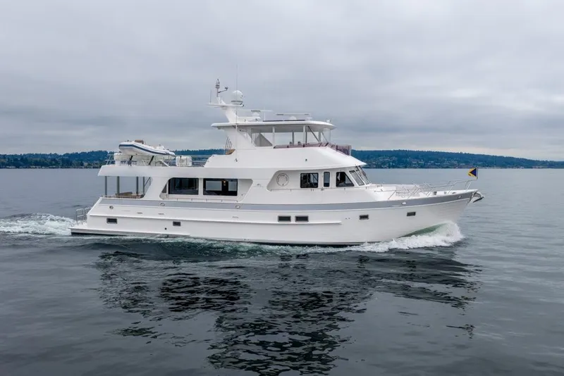 Slide: The Image of 2022 Outer Reef 720 Motor Yacht cruising on calm waters under cloudy skies. - 147