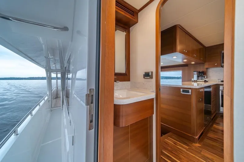 Slide: The Image of Luxurious interior of 2022 Outer Reef 720 Motor Yacht with wooden finishes and ocean view. - 24