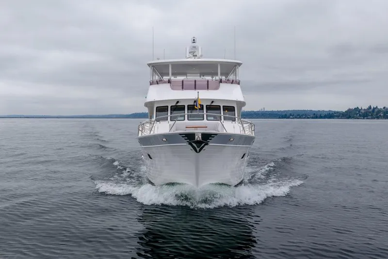 Slide: The Image of 2022 Outer Reef Yachts 720 Motor Yacht cruising on calm waters under cloudy skies. - 3
