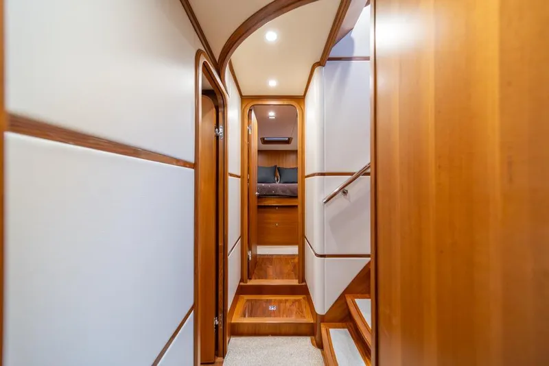 Slide: The Image of Luxurious interior hallway of 2022 Outer Reef 720 Motor Yacht with wood accents. - 45