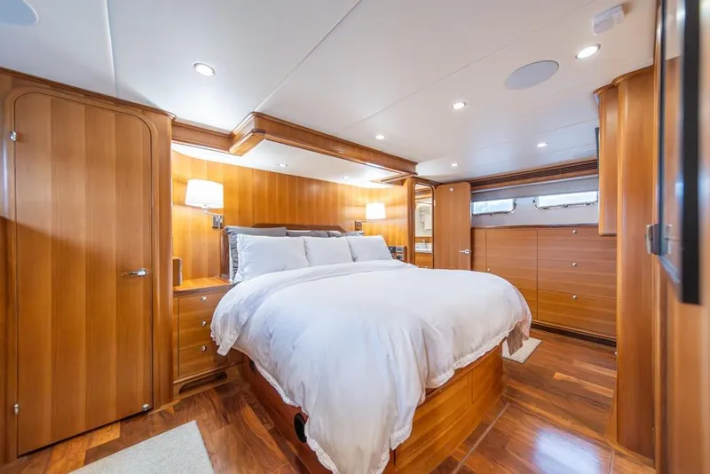 Slide: The Image of Luxurious bedroom interior of 2022 Outer Reef 720 Motor Yacht with elegant wood finish. - 49