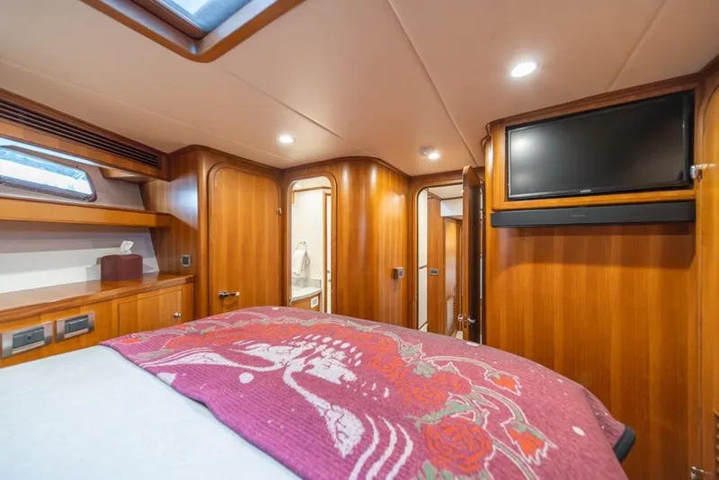 Slide: The Image of Luxurious 2022 Outer Reef 720 Motor Yacht bedroom with wood paneling and modern amenities. - 62