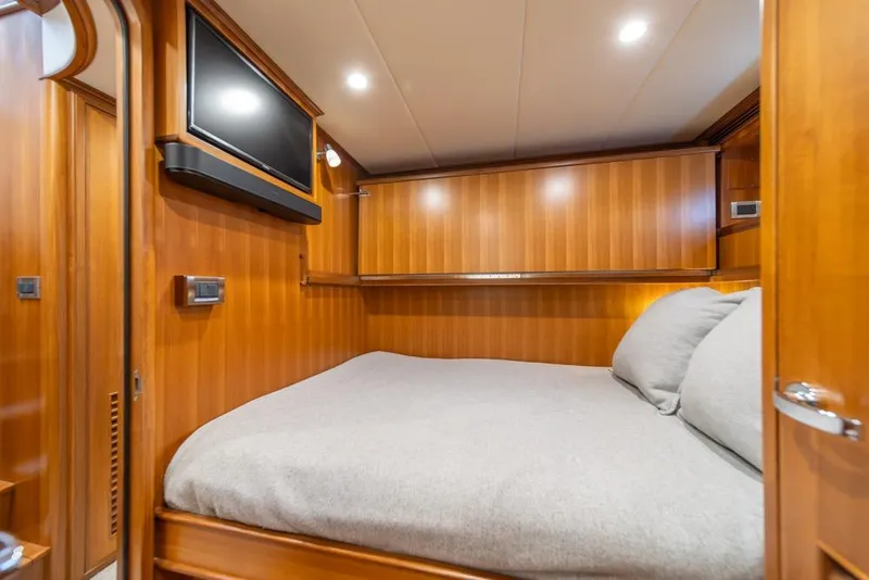 Slide: The Image of Luxurious cabin interior of 2022 Outer Reef 720 Motor Yacht with wood paneling and TV. - 66