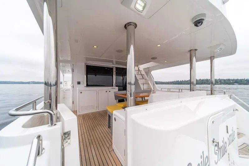 Slide: The Image of 2022 Outer Reef 720 Motor Yacht deck with seating and ocean view. - 76