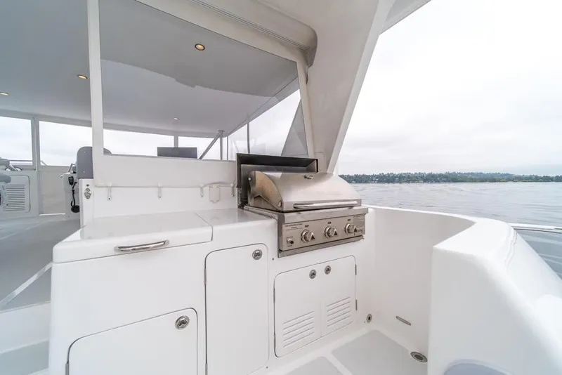 Slide: The Image of Outdoor kitchen on 2022 Outer Reef 720 Motor Yacht with stainless steel grill. - 90