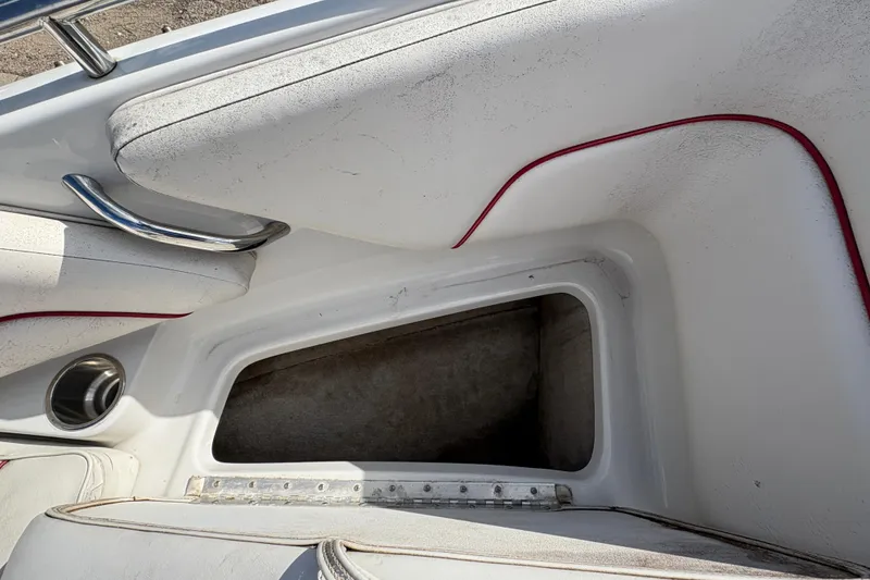 Slide: The Image of 2007 Crownline 190 SS boat interior storage compartment with white and red trim. - 11