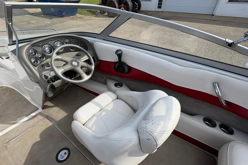 Slide: The Image of 2007 Crownline 190 SS boat interior with steering wheel and dashboard controls. - 13
