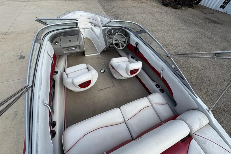 Slide: The Image of 2007 Crownline 190 SS boat interior with white and red seating, dashboard, and open deck. - 23