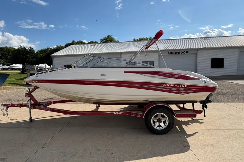 Slide: The Image of 2007 Crownline 190 SS boat on trailer, parked outside a showroom. - 4