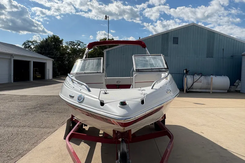 Slide: The Image of 2007 Crownline 190 SS boat on trailer, parked outdoors under a partly cloudy sky. - 6