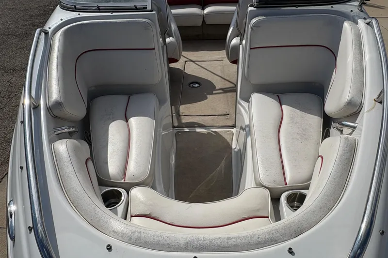 Slide: The Image of 2007 Crownline 190 SS boat interior with white and red seating, cup holders, and spacious layout. - 7