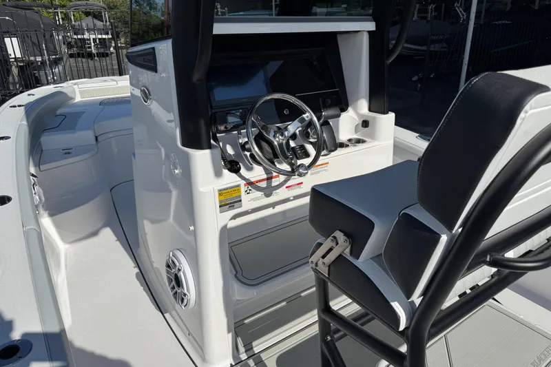 Slide: The Image of 2026 Blackfin 242HB boat interior with steering console and seating. - 15