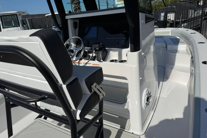 Slide: The Image of 2026 Blackfin 242HB boat interior with steering wheel and control panel. - 16