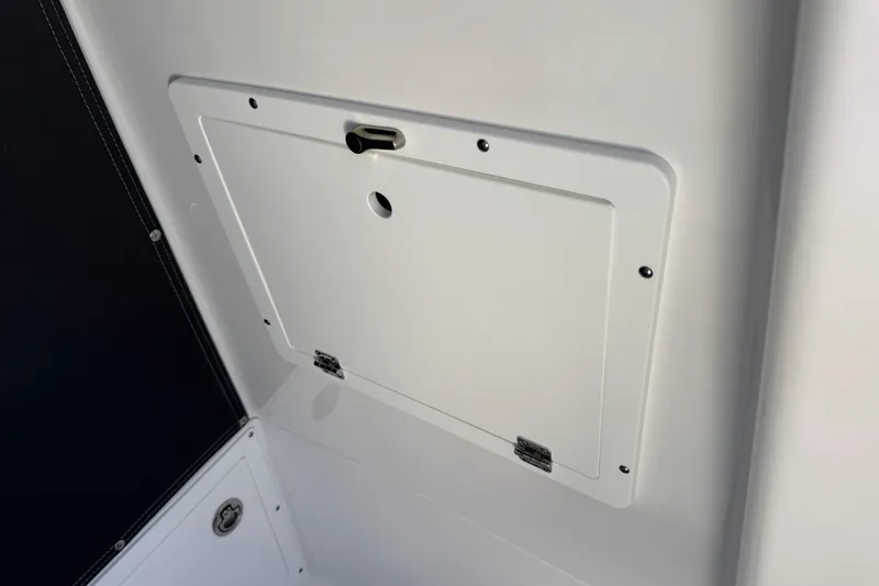 Slide: The Image of 2026 Blackfin 242HB boat storage compartment with secure latch and sleek design. - 21