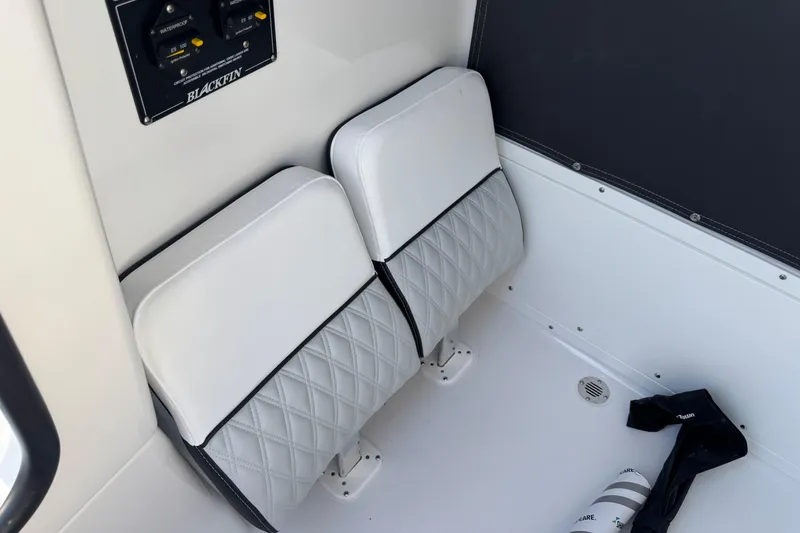 Slide: The Image of 2026 Blackfin 242HB boat interior with white cushioned seats and control panel. - 23