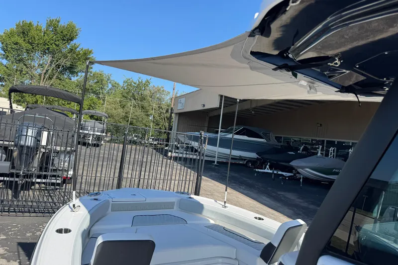Slide: The Image of 2026 Blackfin 242HB boat displayed at a dealership with other boats in the background. - 27