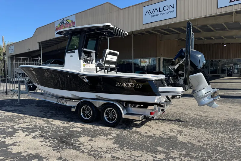 Slide: The Image of 2026 Blackfin 242HB boat on trailer outside dealership, featuring sleek design and powerful engine. - 3