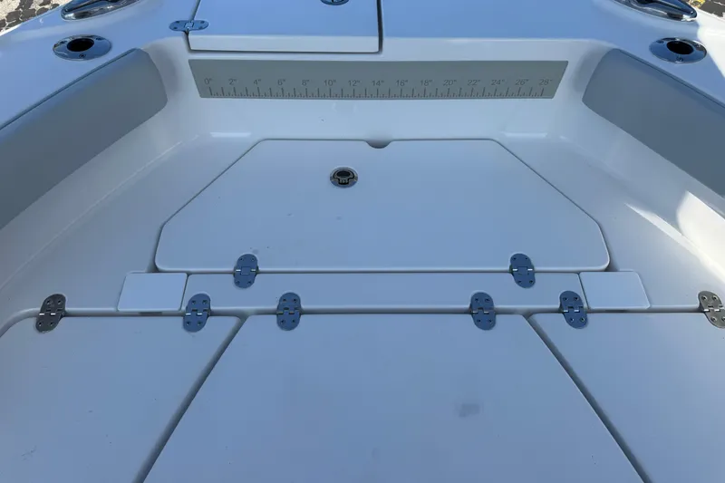 Slide: The Image of 2026 Blackfin 242HB boat deck with storage compartments and measurement scale. - 34