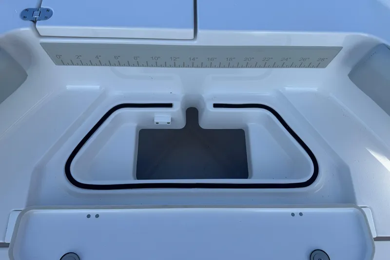 Slide: The Image of 2026 Blackfin 242HB boat storage compartment with integrated measuring ruler. - 35