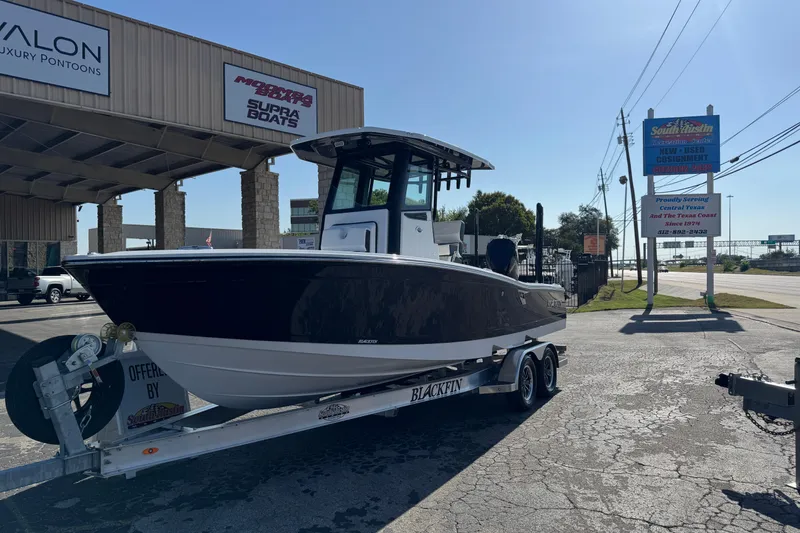 Slide: The Image of 2026 Blackfin 242HB boat on trailer at dealership, sunny day, outdoor display. - 4