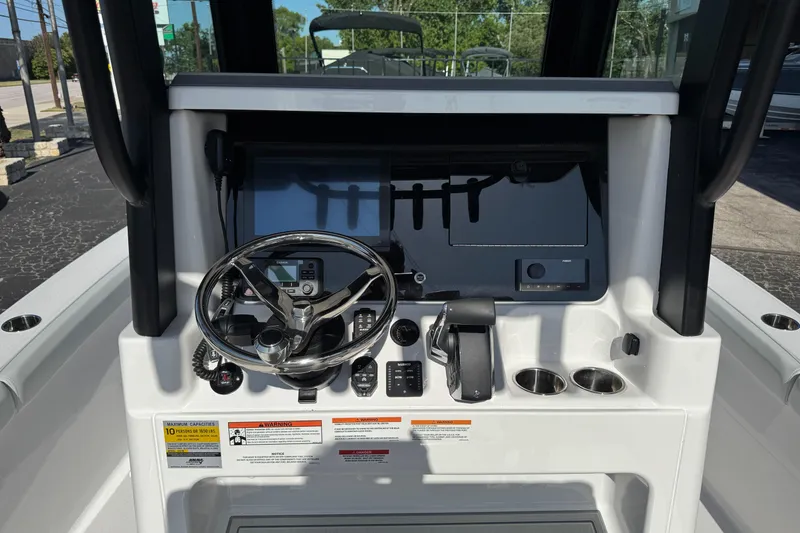 Slide: The Image of 2026 Blackfin 242HB boat dashboard with steering wheel and control panel. - 6