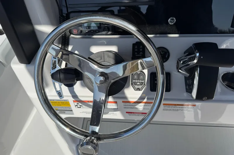 Slide: The Image of Steering wheel and controls of 2026 Blackfin 242HB boat cockpit. - 7