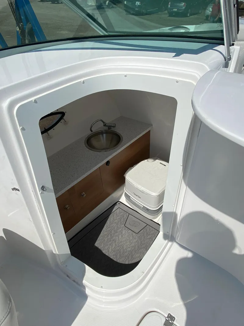 Slide: The Image of 2023 Hurricane SD 2690 OB boat interior with sink and storage cabinet. - 17