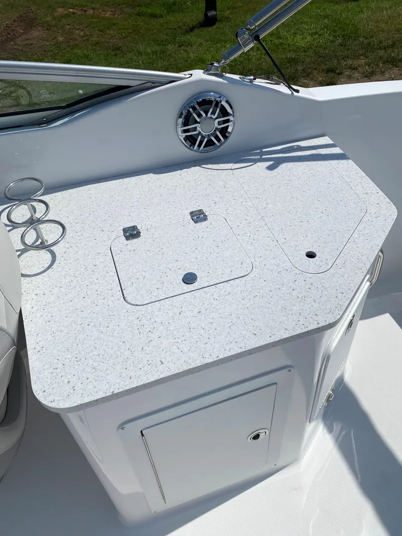 Slide: The Image of 2023 Hurricane SD 2690 OB boat interior with sleek countertop and built-in cup holders. - 18