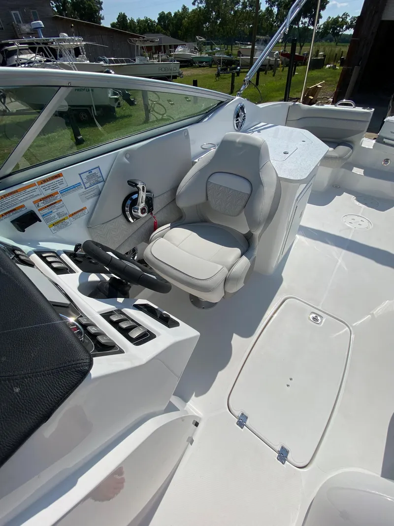 Slide: The Image of 2023 Hurricane SD 2690 OB boat interior with steering wheel and seating area. - 22