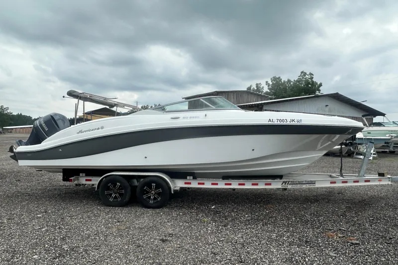 Slide: The Image of 2023 Hurricane SD 2690 OB boat on trailer, parked outdoors under cloudy sky. - 29