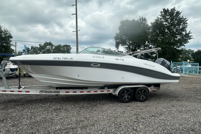 Slide: The Image of 2023 Hurricane SD 2690 OB boat on trailer, parked outdoors under cloudy sky. - 34
