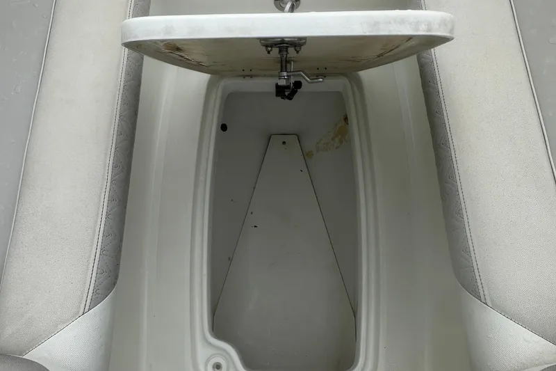 Slide: The Image of Open storage compartment in 2023 Hurricane SD 2690 OB boat, featuring white interior. - 43