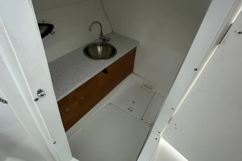 Slide: The Image of 2023 Hurricane SD 2690 OB boat interior with sink and storage cabinets. - 45