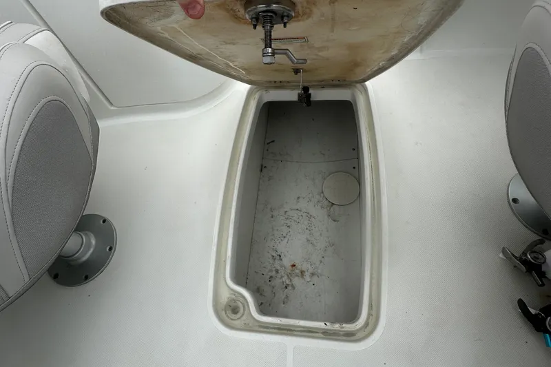 Slide: The Image of 2023 Hurricane SD 2690 OB boat storage compartment with open hatch and seating. - 46