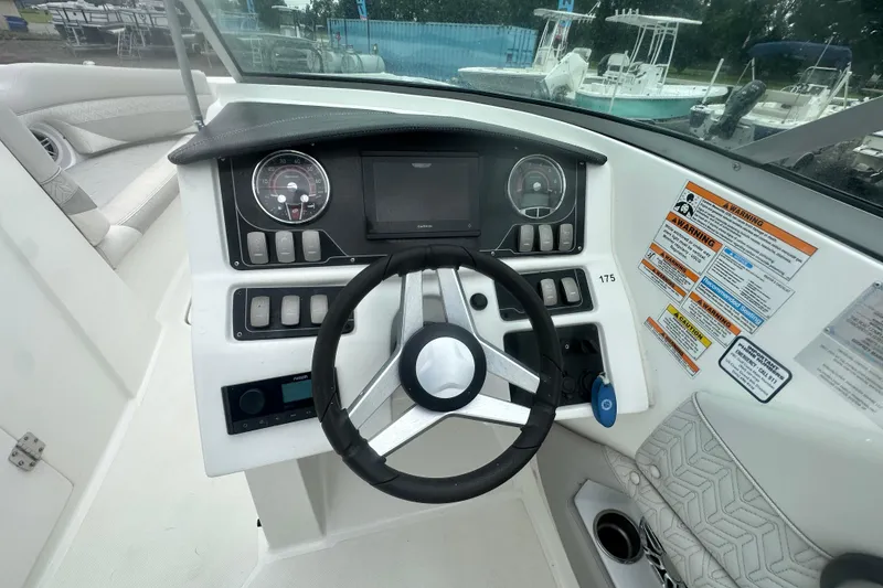 Slide: The Image of 2023 Hurricane SD 2690 OB boat dashboard with steering wheel and control panel. - 49