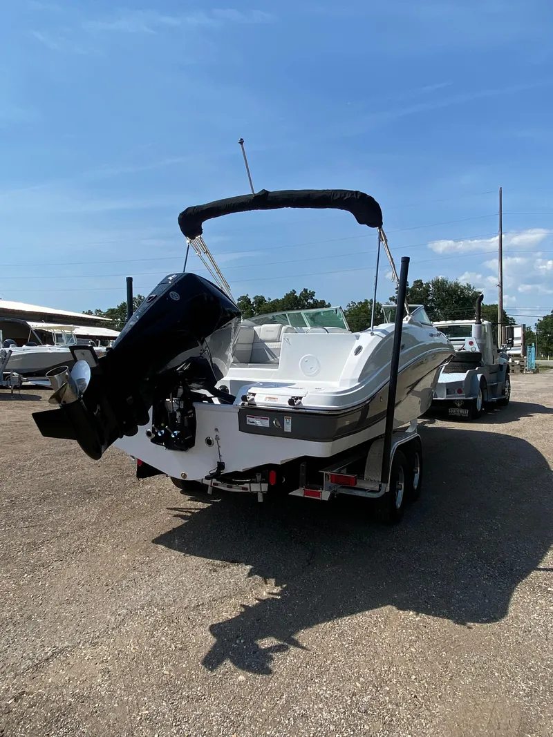 Slide: The Image of 2023 Hurricane SD 2690 OB boat on trailer, parked outdoors under clear blue sky. - 5