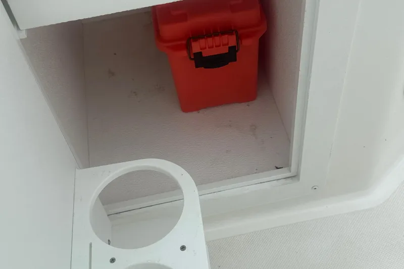 Slide: The Image of Red storage box inside 2023 Hurricane SD 2690 OB boat compartment. - 53