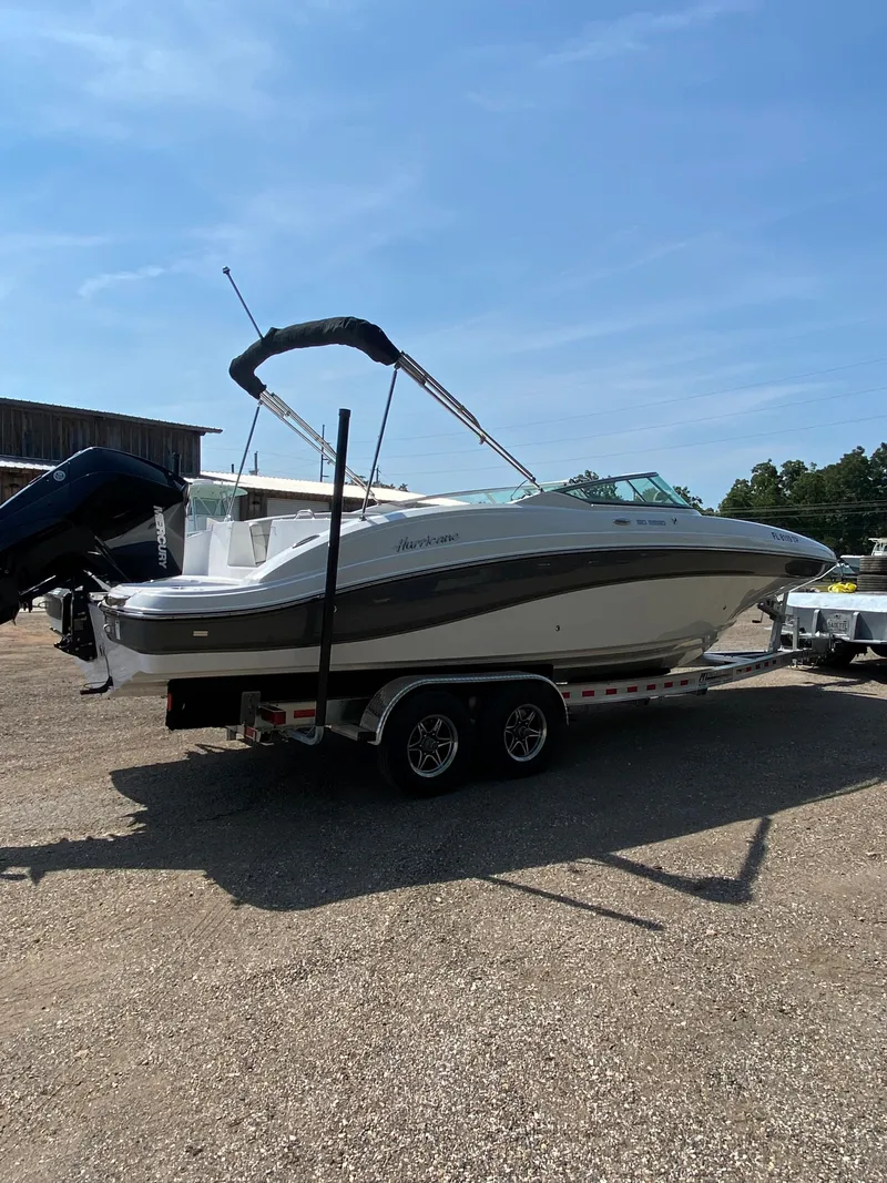 Slide: The Image of 2023 Hurricane SD 2690 OB boat on trailer, parked outdoors under clear sky. - 6