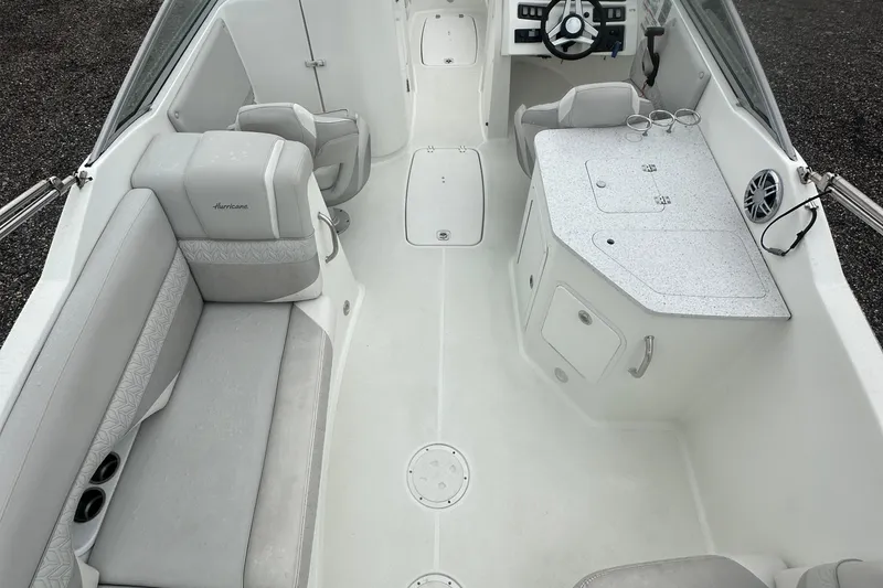 Slide: The Image of 2023 Hurricane SD 2690 OB boat interior with seating, steering wheel, and storage compartments. - 64