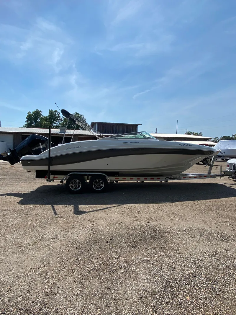 Slide: The Image of 2023 Hurricane SD 2690 OB boat on trailer under clear blue sky. - 7