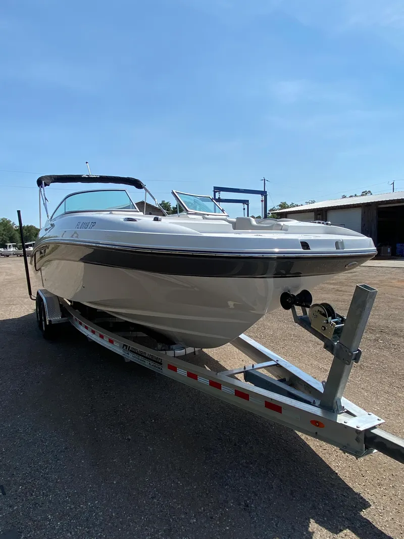 Slide: The Image of 2023 Hurricane SD 2690 OB boat on trailer, parked outdoors under clear sky. - 9
