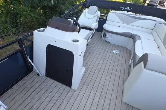 Slide: The Image of 2023 Avalon 2380 VENTURE CRUISE boat interior with modern seating and steering console. - 16