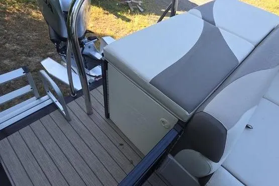 Slide: The Image of 2023 Avalon 2380 VENTURE CRUISE boat interior with cushioned seating and motor. - 18