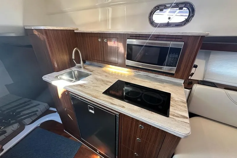 Slide: The Image of Control panel on 2020 Pursuit OS 355 Offshore boat with wood finish interior. - 22