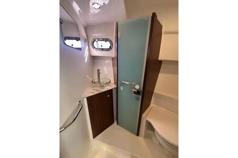 Slide: The Image of 2020 Pursuit OS 355 Offshore boat deck with storage compartments and outboard motors. - 30