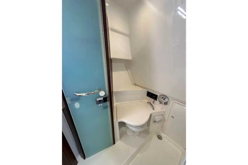 Slide: The Image of 2020 Pursuit OS 355 Offshore boat bathroom with modern sink and mirror. - 32