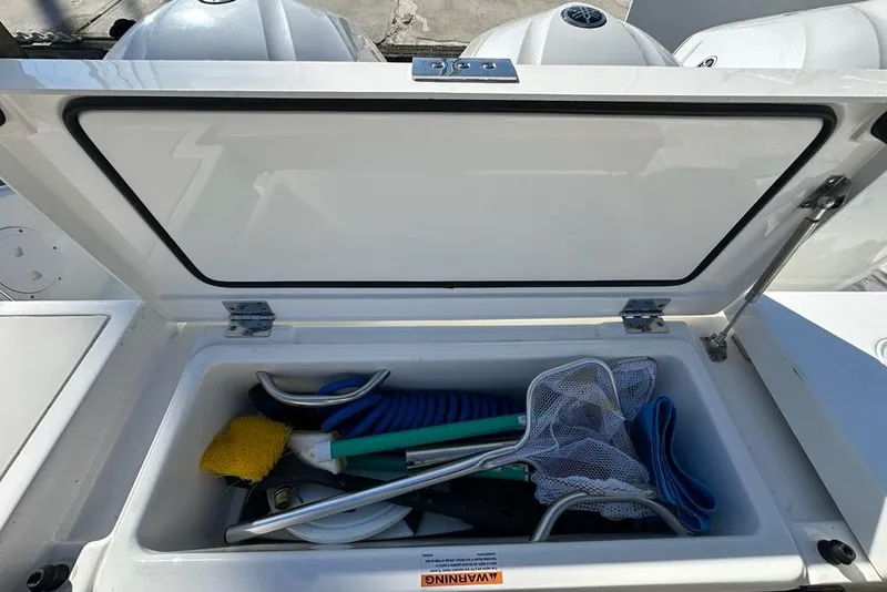 Slide: The Image of Storage compartment on a 2020 Pursuit OS 355 Offshore boat with fishing gear and controls. - 40