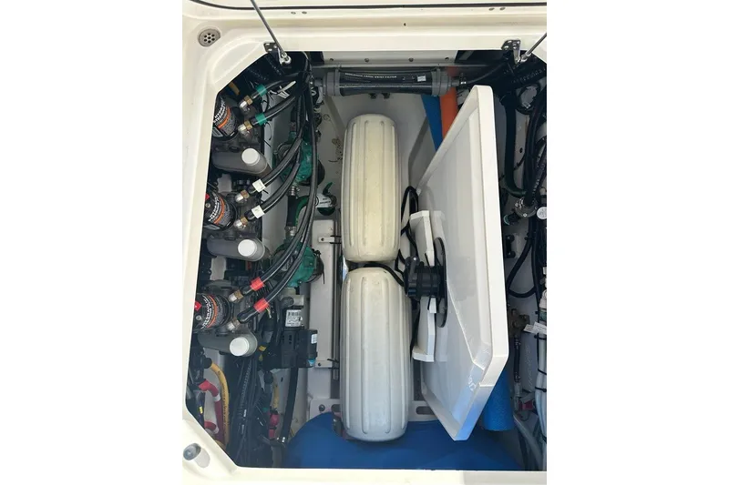 Slide: The Image of Storage compartment with tools and accessories on a 2020 Pursuit OS 355 Offshore boat. - 45
