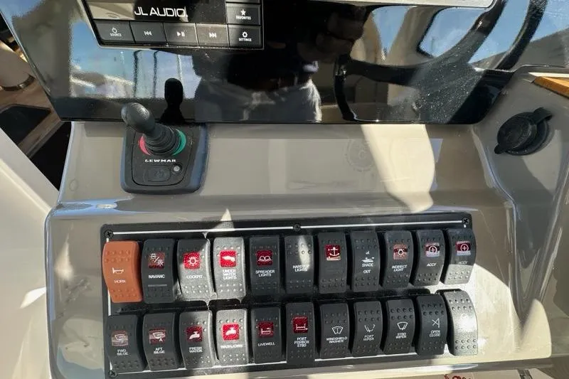 Slide: The Image of 2020 Pursuit OS 355 Offshore boat dashboard with navigation screens and controls. - 9
